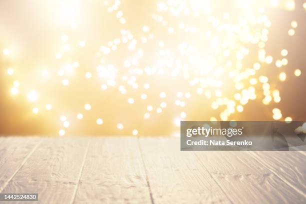 empty rustic white wooden table with blurred christmas lights on background. - christmas montage stock pictures, royalty-free photos & images