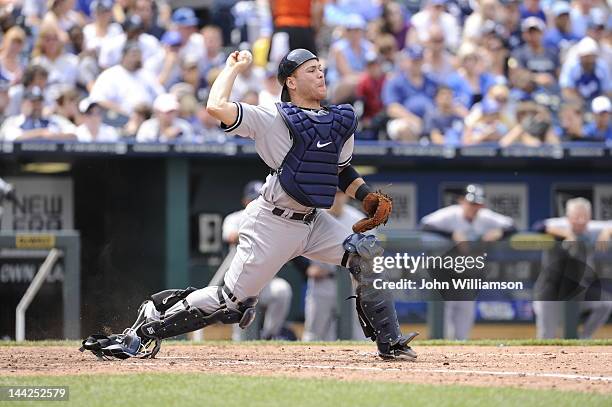 Catcher Russell Martin of the New York Yankees throws to second base as the baserunner advances on a wild pitch in the game against the Kansas City...