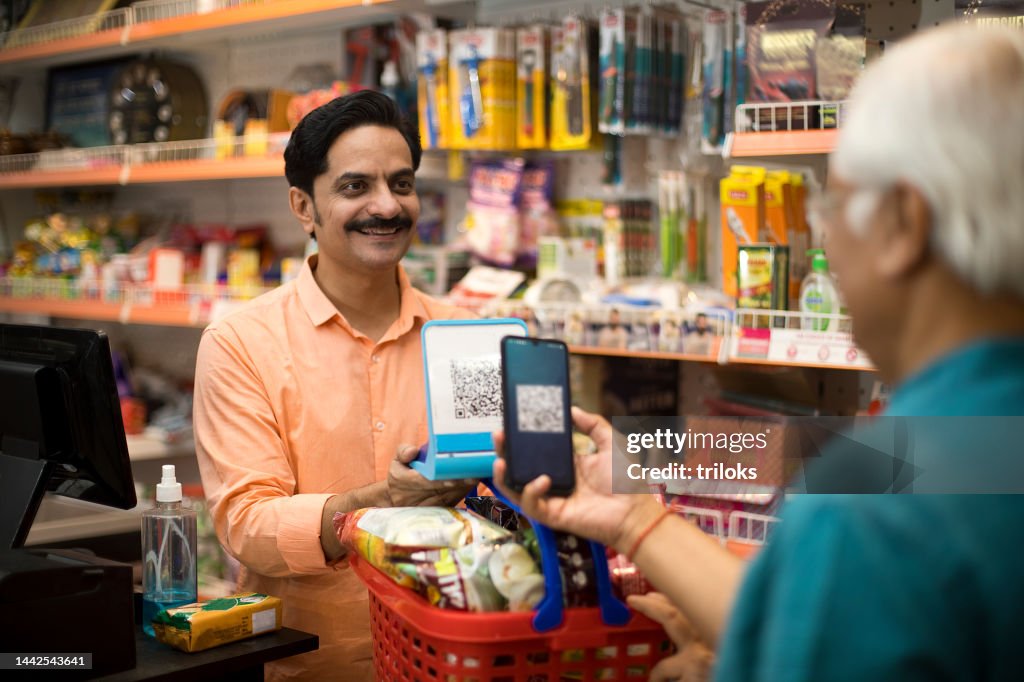 Customer scanning QR code with smartphone at store