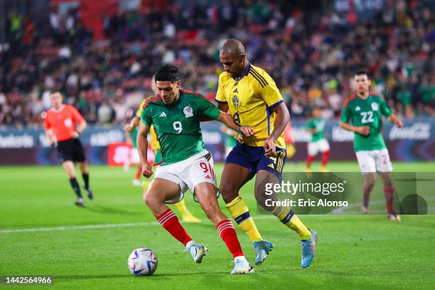 Raul Jimenez of Mexico is tackled by Isak Hien of Sweden during the friendly match between Mexico and Sweden at Montilivi Stadium on November 16,...