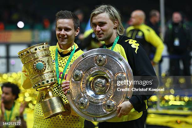 Chris Loewe and Marcel Schmelzer of Dortmund poses with the trophies after winning the DFB Cup final match between Borussia Dortmund and FC Bayern...