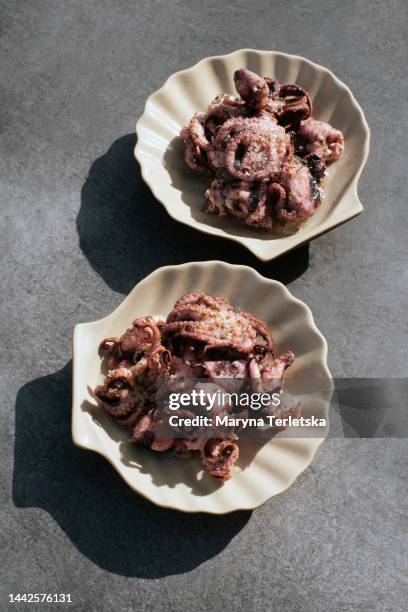small cooked octopuses. marinated octopus. snack. food. seafood. - lula frita imagens e fotografias de stock