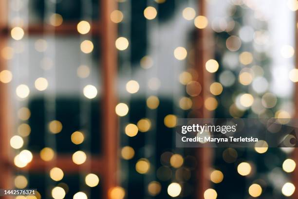 blurred defocus christmas background. blurred dark background with christmas tree. new year. christmas. christmas decor. christmas tree. christmas background. holiday. - celebrate living stockfoto's en -beelden