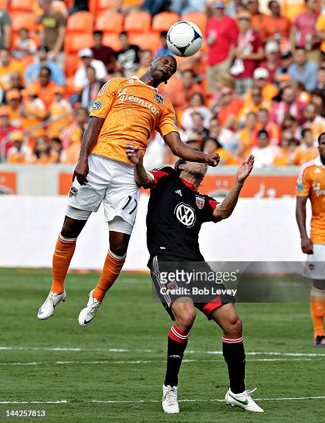Luiz Camargo of the Houston Dynamo gives Josh Wolf a forearm to the face as he heads the ball away in the second half at BBVA Compass Stadium on May...