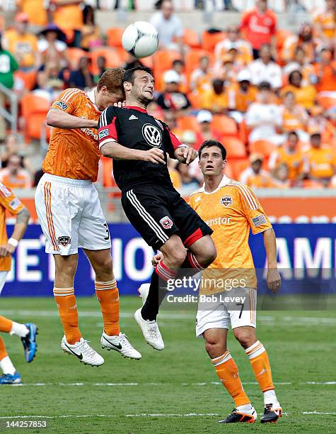 Hamdi Salihi of D.C. United goes up for a header as Adre Hainult appplies pressure from behind at BBVA Compass Stadium on May 12, 2012 in Houston,...