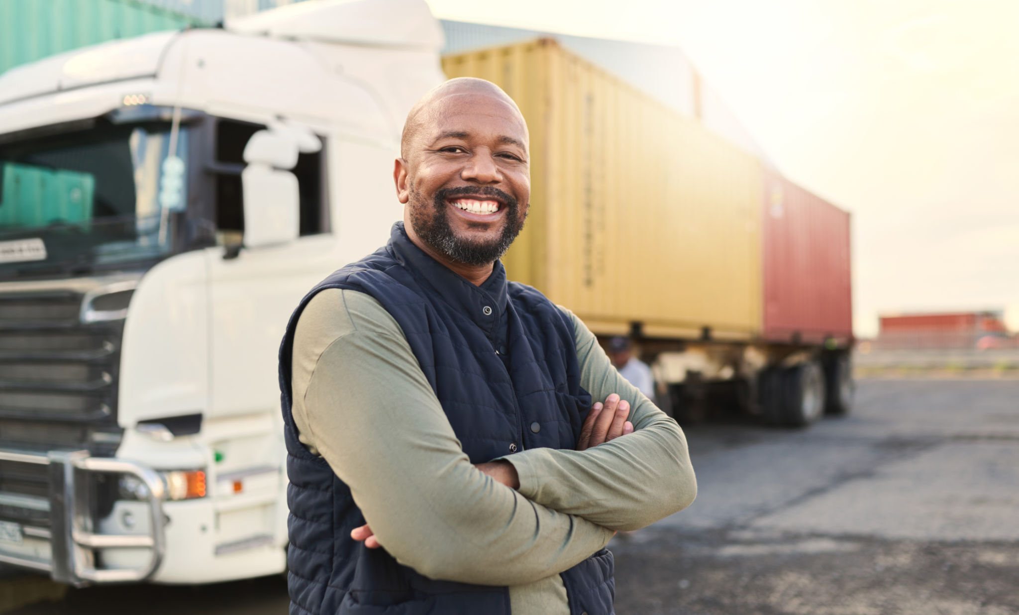 Delivery, container and happy truck driver moving industry cargo and freight at a shipping supply chain or warehouse. Smile, industrial and black man ready to transport ecommerce trade goods or stock Delivery, container and happy truck driver moving industry cargo and freight at a shipping supply chain or warehouse. Smile, industrial and black man ready to transport ecommerce trade goods or stock