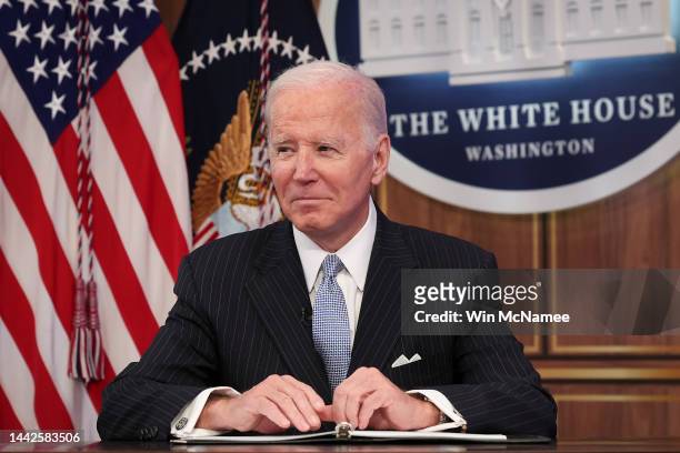 President Joe Biden looks toward reporters as they shout questions during an event with business and labor leaders at the White House complex...