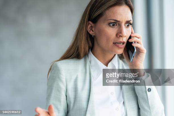 business woman talking on the phone - anger business stock pictures, royalty-free photos & images