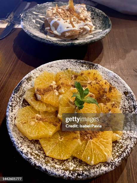 orange slices with cinnamon on plate - dessert topping stock pictures, royalty-free photos & images