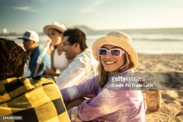 portrait of young woman with friends on the beach - mexican picnic stock pictures, royalty-free photos & images