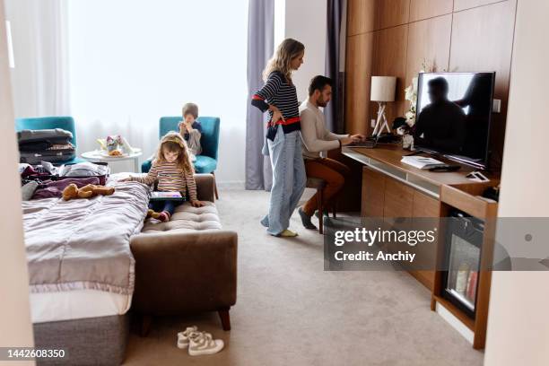 family relaxing in the hotel room - four people walking away stock pictures, royalty-free photos & images