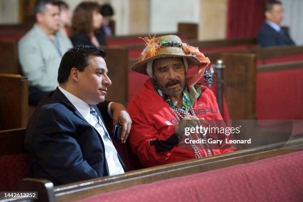 In the public seating section of City Hall's chamber Council Member José Huizar converses with a gadfly wearing beads and a straw hat on February 13,...