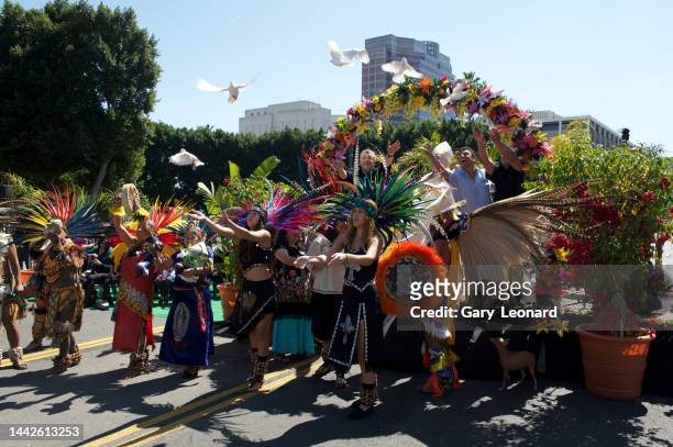 At El Pueblo during the Blessing of the Animals Council Member José Huizar with Cardinal Gomez and others on stage and feathered Aztec dancers in...