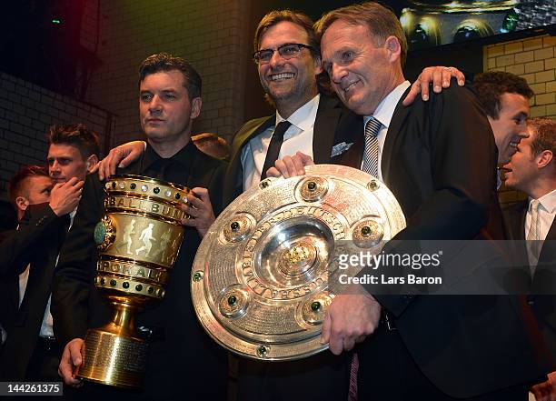 Head coach Juergen Klopp celebrates with manager Michael Zorc and managing director Hans Joachim Watzke during the Borussia Dortmund party at the...