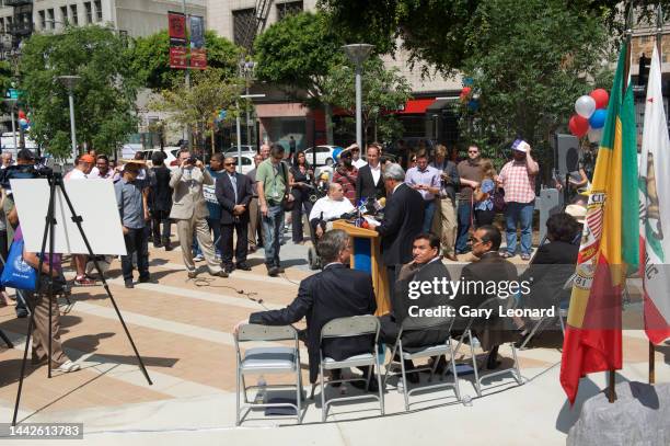 At Spring Street Park's Ribbon Cutting Council Member José Huizar seated behind the podium gazes behind him with hand on chin on June 17, 2013 in Los...