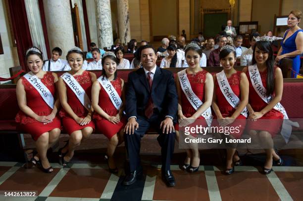 In City Hall Council's Chamber Council Member José Huizar poses for a group portrait sitting with the Nisei Week queen and princesses on August 23,...