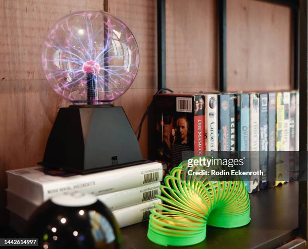 Slinky, Magic 8 ball and Plasma Ball are seen on display at the Blockbuster Speakeasy pop-up media preview on November 18, 2022 in Los Angeles,...