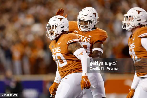 Byron Murphy II of the Texas Longhorns is congratulated by Barryn Sorrell after a play on special teams in the first half against the TCU Horned...