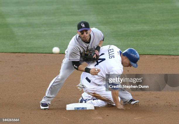 Second baseman Marco Scutaro of the Colorado Rockies throws to first to complete a double play ending the first inning after forcing out Mark Elliis...