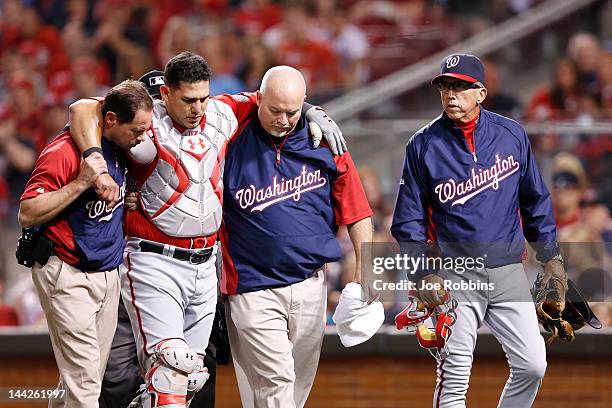 Manager Davey Johnson of the Washington Nationals looks on as catcher Wilson Ramos is helped off the field after suffering an injury against the...