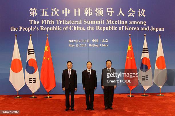 South Korea's President Lee Myung-bak , China's Premier Wen Jiabao and Japan's Prime Minister Yoshihiko Noda pose for photographs in front of their...