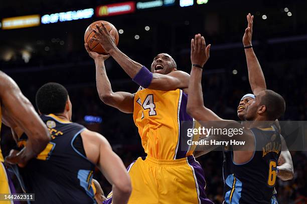 Kobe Bryant of the Los Angeles Lakers goes up for a shot over Arron Afflalo of the Denver Nuggets in the first half in Game Seven of the Western...