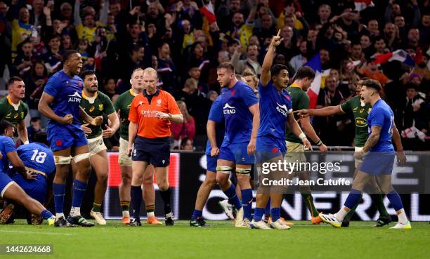 Cameron Woki; Anthony Jelonch; Yoram Moefana; Matthieu Jalibert of France celebrate the victory while referee Wayne Barnes of England looks on...