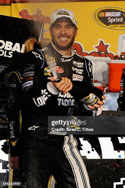Jimmie Johnson, driver of the Lowe's/Kobalt Tools Chevrolet, celebrates in Victory Lane after winning the NASCAR Sprint Cup Series Bojangles'...