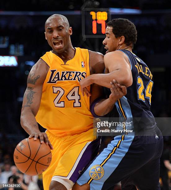 Kobe Bryant of the Los Angeles Lakers drives on Andre Miller of the Denver Nuggets in the third quarter in Game Seven of the Western Conference...