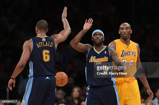 Arron Afflalo and Ty Lawson of the Denver Nuggets react in the first half alongside Kobe Bryant of the Los Angeles Lakers in Game Seven of the...