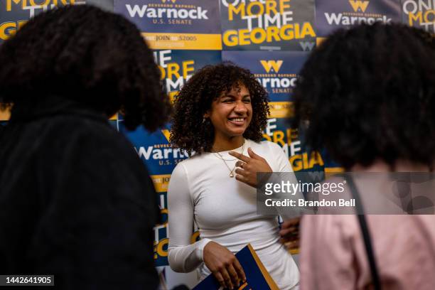 College student reacts after taking a selfie with U.S. Sen. Raphael Warnock during a campaign stop at Georgia Tech on November 18, 2022 in Atlanta,...