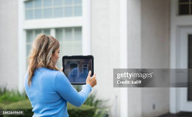 female home appraiser photographs house with tablet - real estate appraisal stock pictures, royalty-free photos & images