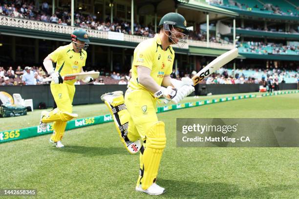 David Warner and Travis Head of Australia walk onto the field to bat during Game 2 of the One Day International series between Australia and England...