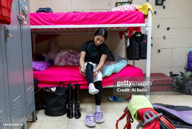 Student Jockey Valeria Melendez prepares her gear with her classmates in the locker room before their race at the Vocational Equestrian Agustín...