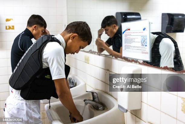 Student Jockeys Carlos Barbosa and Steven Monserrate prepare in the locker room prior to their race at the Vocational Equestrian Agustín Mercado...