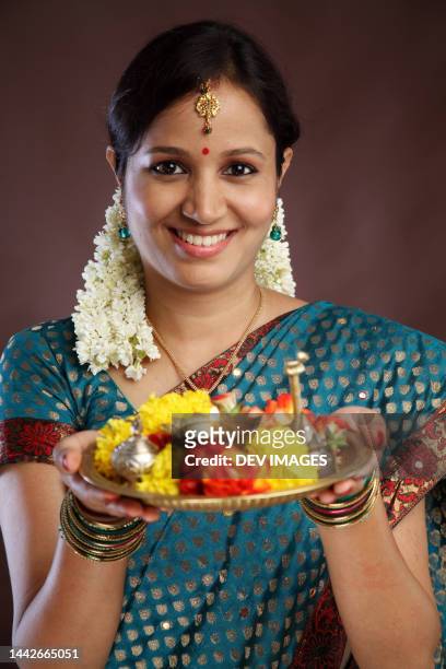 happy young traditional woman religious offerings - hinduism stock pictures, royalty-free photos & images