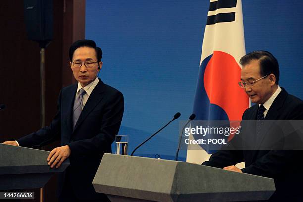 South Korea's President Lee Myung-bak looks on as China's Premier Wen Jiabao speaks during a joint news conference of the fifth trilateral summit...