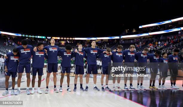 The Virginia Cavaliers stand on the court wearing shirts in honor of three Virginia football players, Lavel Davis Jr., D'Sean Perry and Devin...