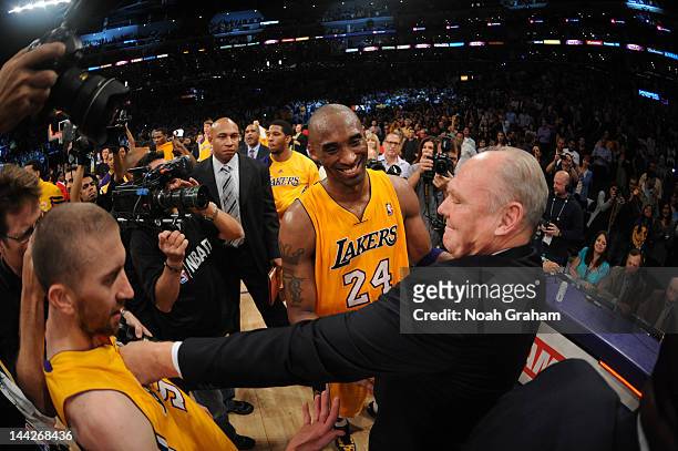 Head Coach George Karl of the Denver Nuggets congratulates Kobe Bryant and Steve Blake of the Los Angeles Lakers following Game Seven of the Western...