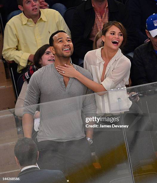 John Legend and Chrissy Teigen attend New York Rangers vs Washington Capitals playoff game at Madison Square Garden on May 12, 2012 in New York City.