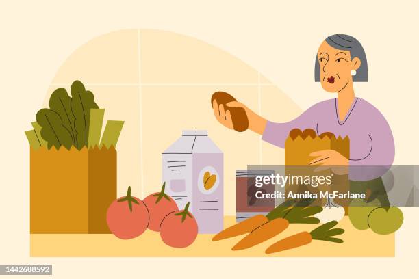 a senior asian woman unpacks healthy vegan groceries from shopping - almond milk stock illustrations