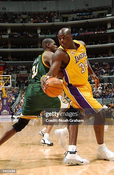 Shaquille O''Neal of the Los Angeles Lakers spins past Jerome James of the Los Seattle SuperSonics during the first half of action at Staples Center...