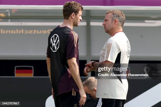 Hans-Dieter Flick, head coach of Germany talks to his player Thomas Müller during the Germany training session at Al Shamal Stadium on November 19,...