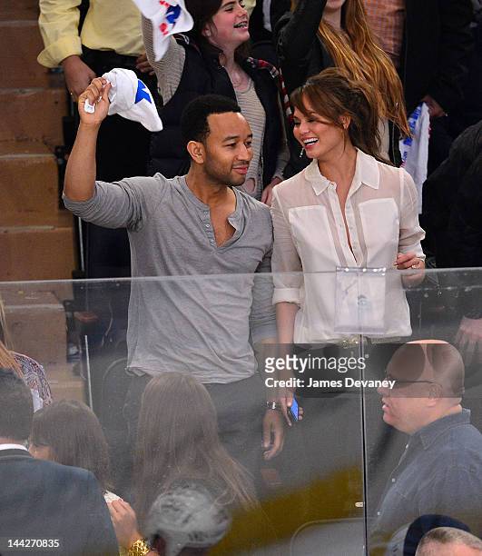 John Legend and Chrissy Teigen attend New York Rangers versus Washington Capitals playoff game at Madison Square Garden on May 12, 2012 in New York...