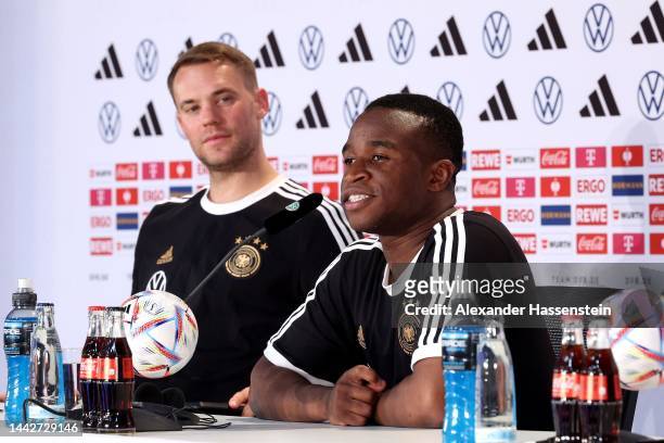 Youssofa Moukoko of Germany talks to the media next to his team mate Manuel Neuerduring the Germany press conference at DFB Media Centre on November...