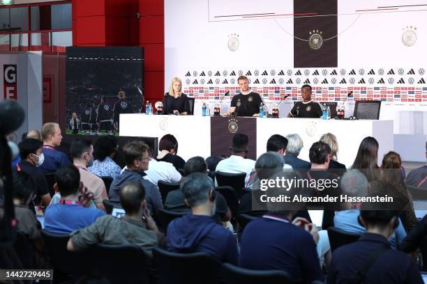 Youssofa Moukoko of Germany talks to the media next to his team mate Manuel Neuerduring the Germany press conference at DFB Media Centre on November...