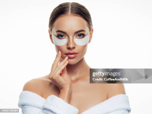 woman with eye patches under her eyes - medical eye patch stockfoto's en -beelden