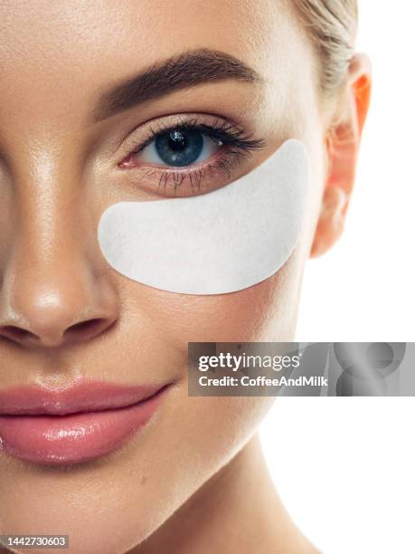 woman with eye patches under her eyes - medical eye patch stockfoto's en -beelden