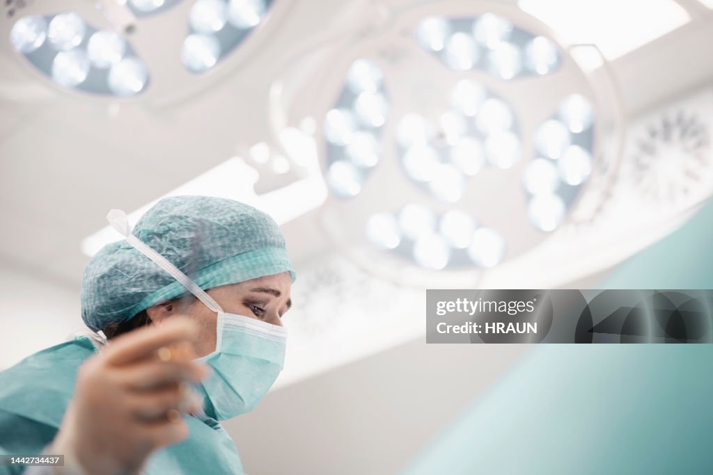 Woman surgeon performing a surgery in operation room