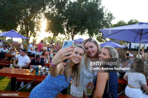 Three ladies take a selfie during Day Three of the DP World Tour Championship on the Earth Course at Jumeirah Golf Estates on November 19, 2022 in...